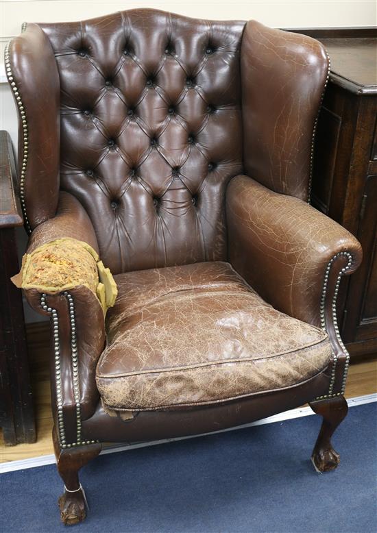 A pair of leather button back wing armchairs (a.f.)
